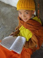 Baby monk reading handbook, Laos.jpg